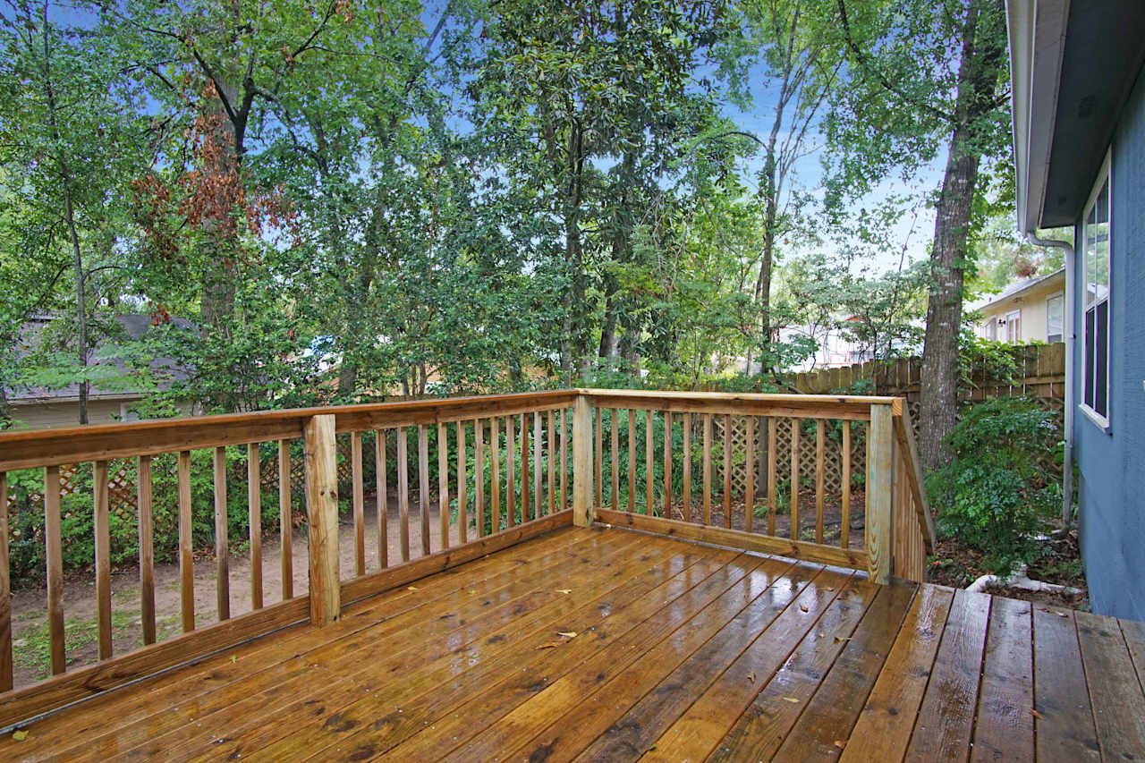 Photo of back deck staircase leading down to the backyard