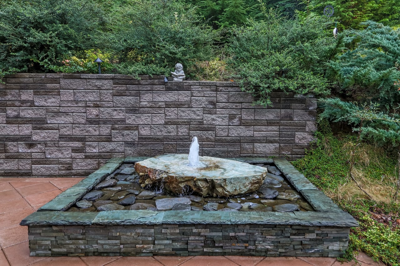 Take a moment to appreciate the charming fountain on the patio, creating a peaceful and inviting ambiance for outdoor gatherings and relaxation.