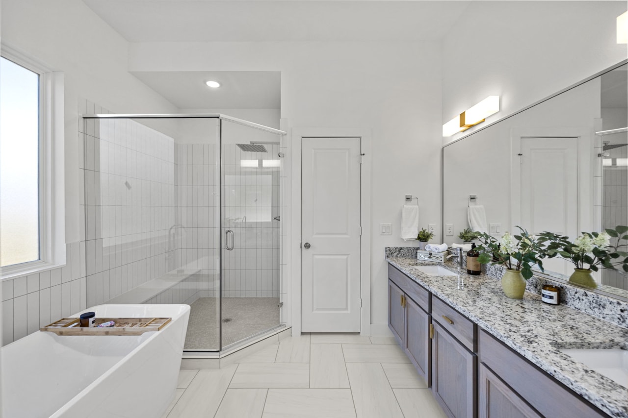 master bathroom with a large tub and shower 