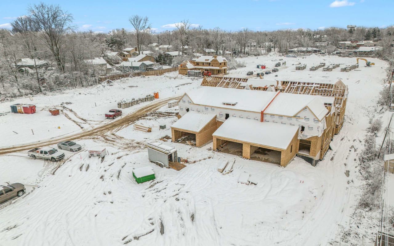 an aerial view of a house under construction during winter