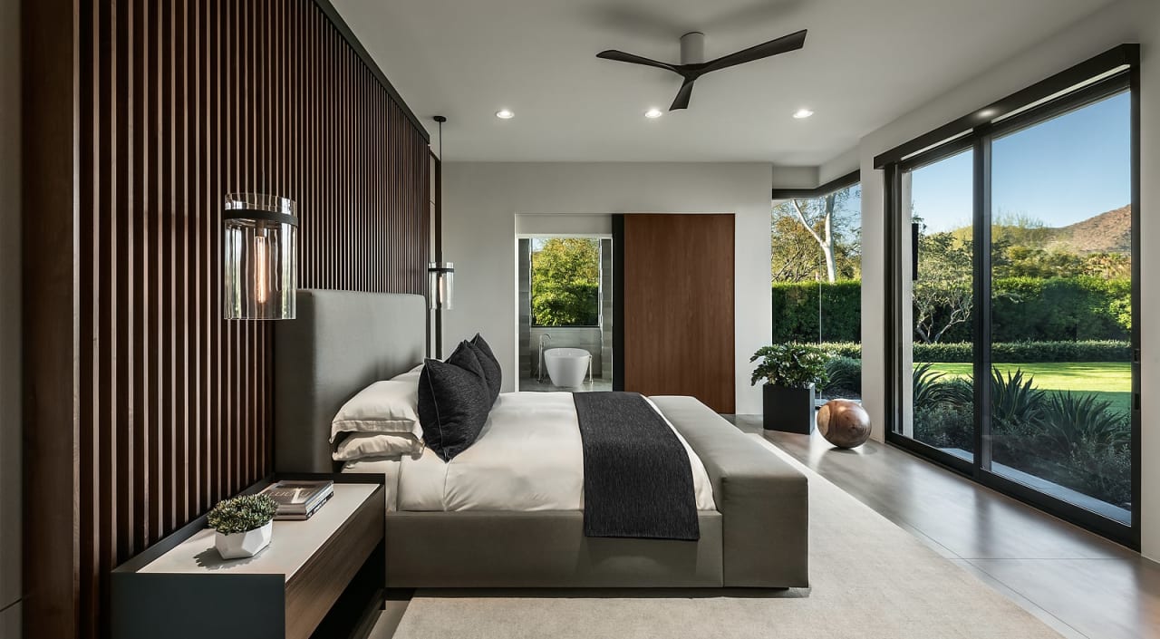 Primary bedroom with custom millwork in modern home