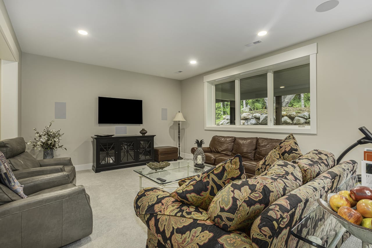 patterned design couch in a living room with a tv