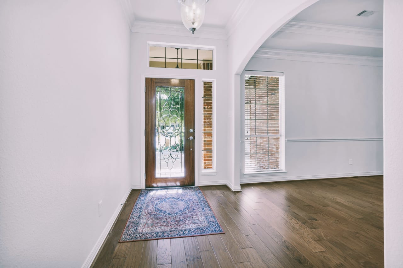 Front entry with beautiful leaded glass door and transom window welcome light into the home!