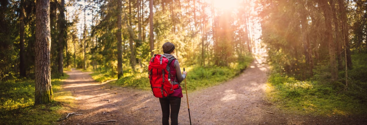 woman at a crossroads hiking making a decision