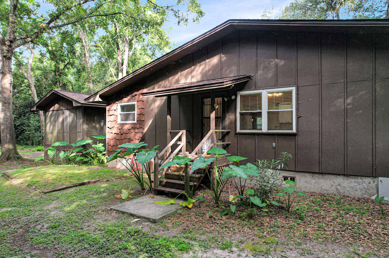 photo of backyard entrance from dining room featuring a lattice staircase