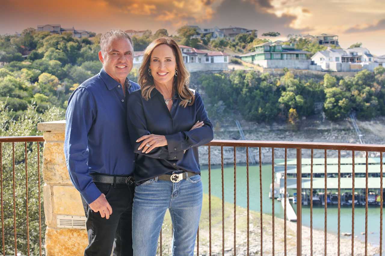 Daniel and Jacquelyn Foreman admiring a scenic lake view from a balcony.