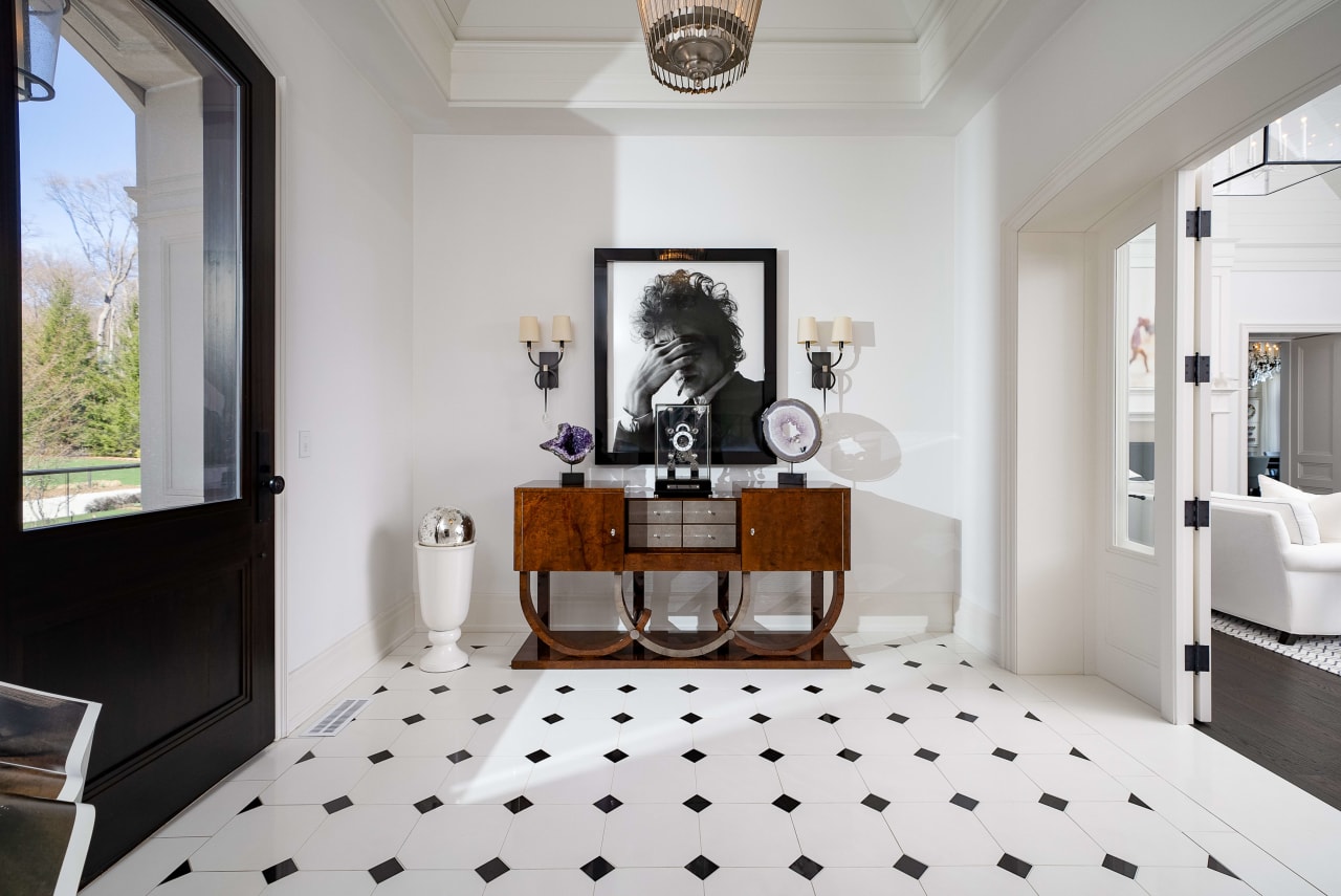 A stylish foyer with a black and white checkered floor