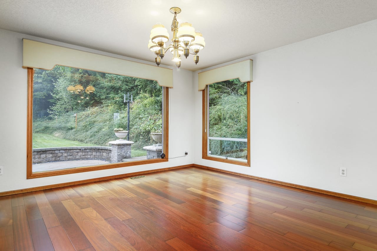 Picture yourself dining in elegance with a picture-perfect view. The formal dining room features a stunning picture window that frames your private backyard, bringing the beauty of the outdoors inside.