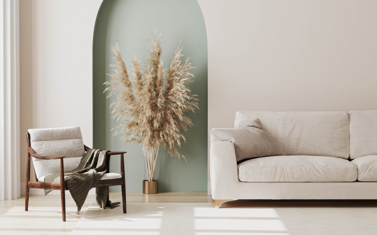 A contemporary living room with a white couch, woven rug, and wood accents.