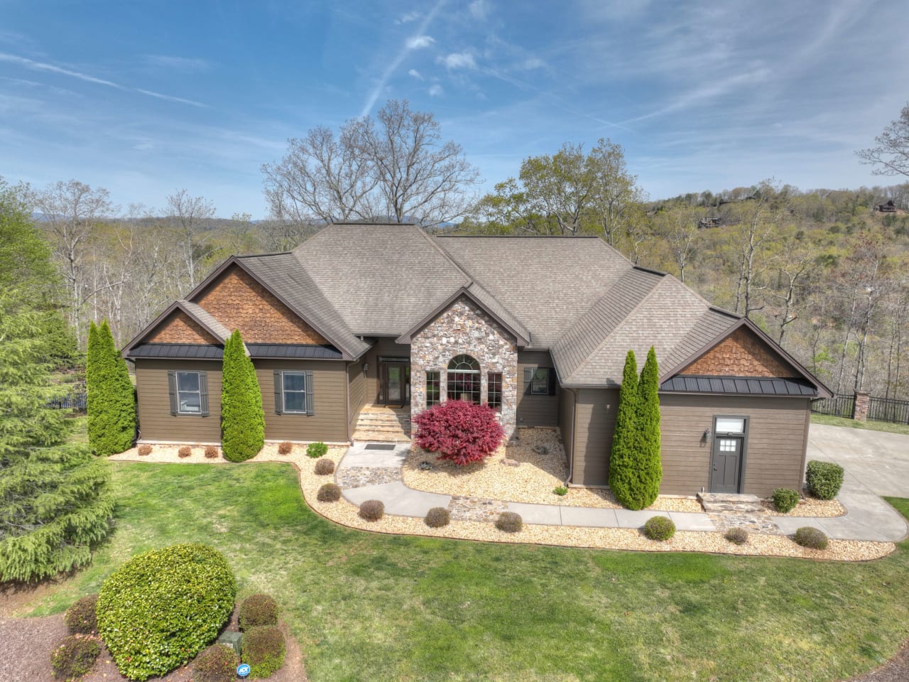 An aerial view of a large, two-story house with a brown roof