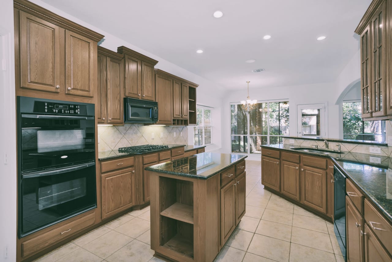 Kitchen with double ovens, gas cookstop, working island, and breakfast bar. Great cabinet space and a walk-in pantry!