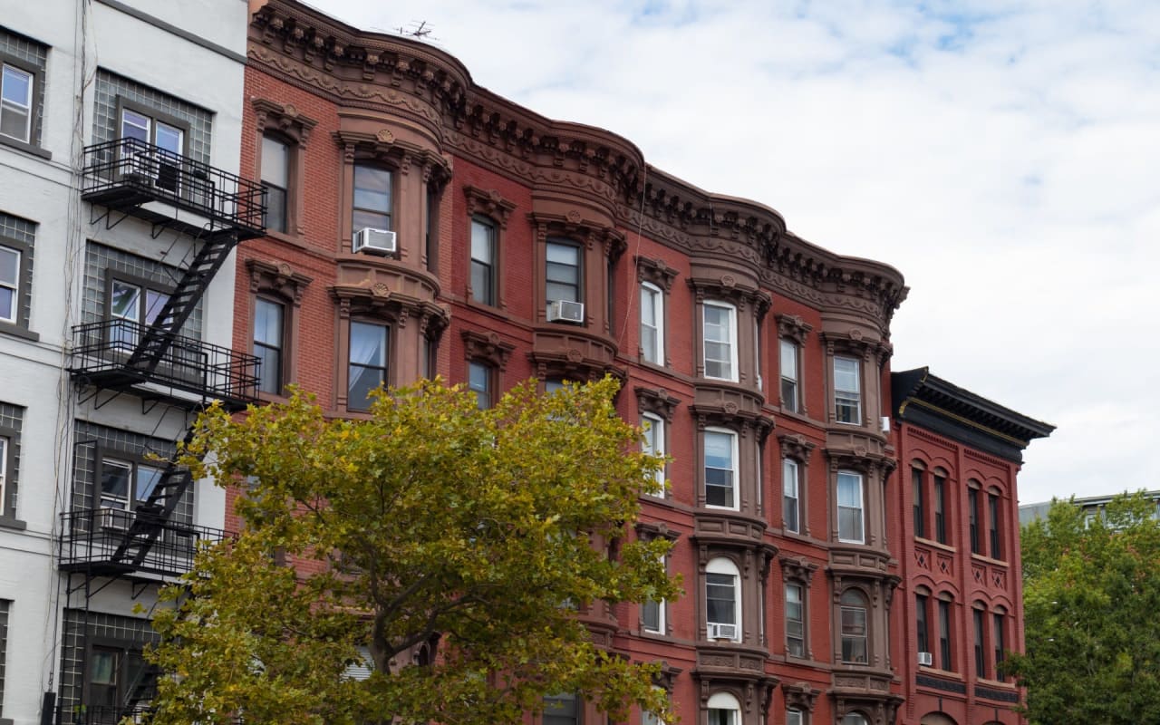 Red brick and white buildings with fire escape