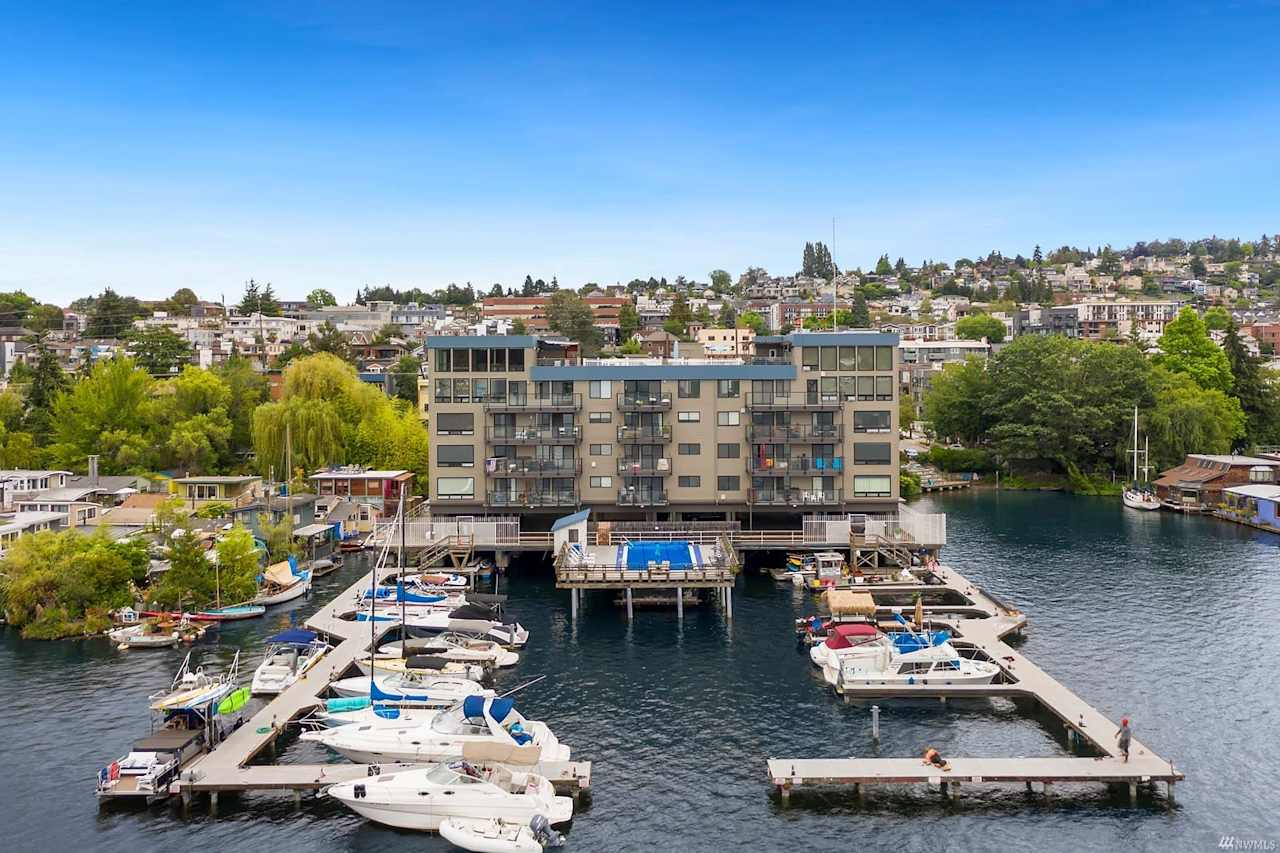 Waterfront condo complex with private marina, boasting luxurious living and scenic views.