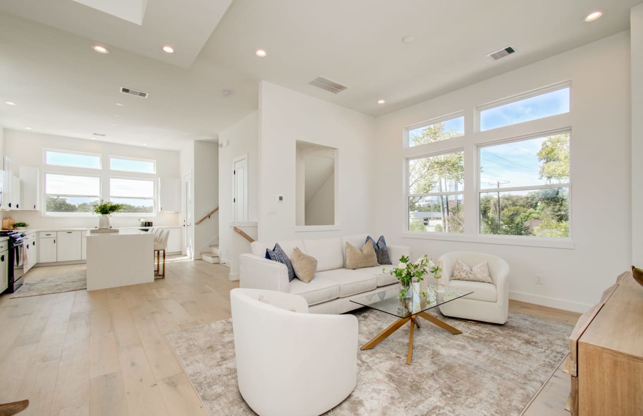 wide angle shot of the second floor with a living room and kitchen area 