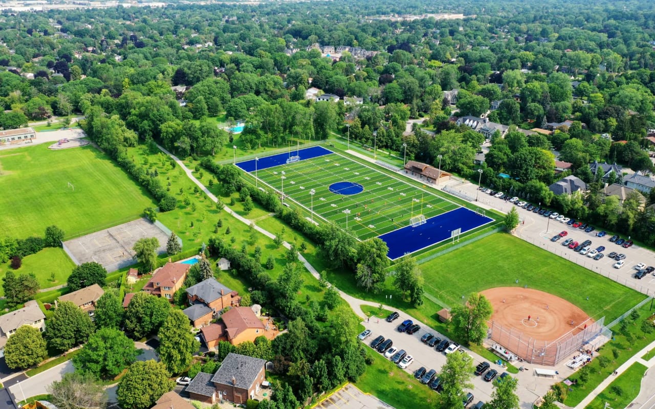 An aerial view of a sports park with a soccer field and a baseball field.