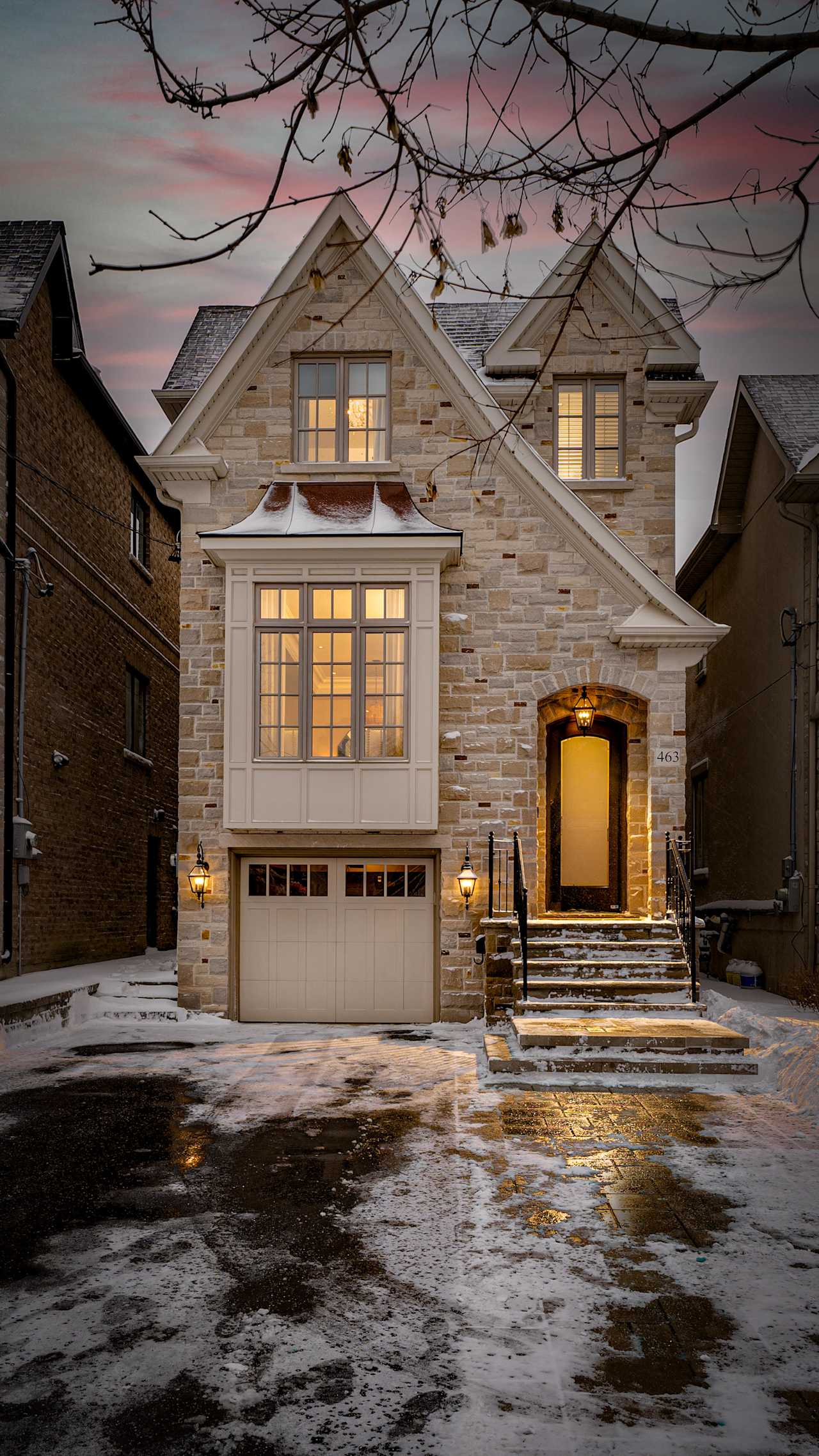 A two-story, single-family house with a brick exterior, a covered porch, and a bay window