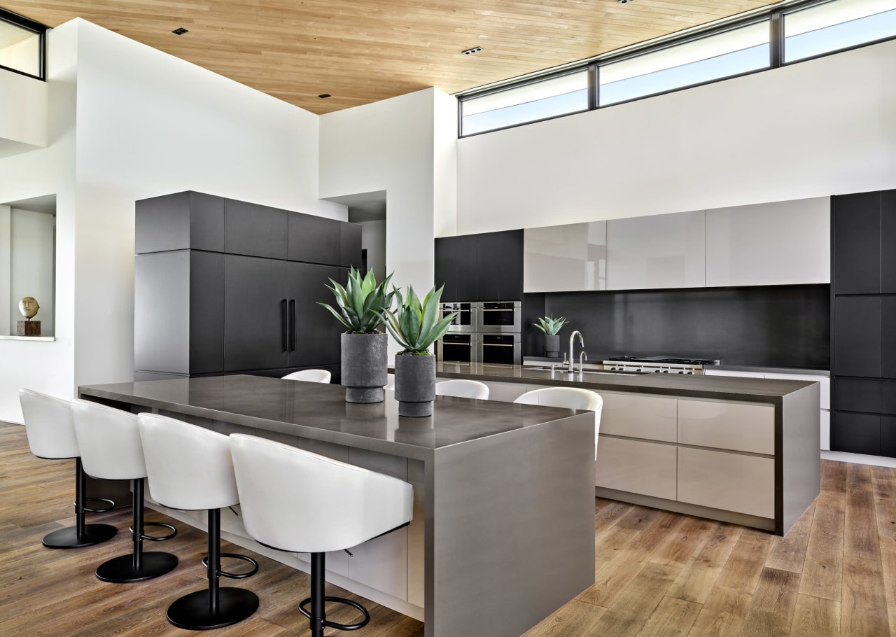 Modern kitchen with dark gray accents and natural light