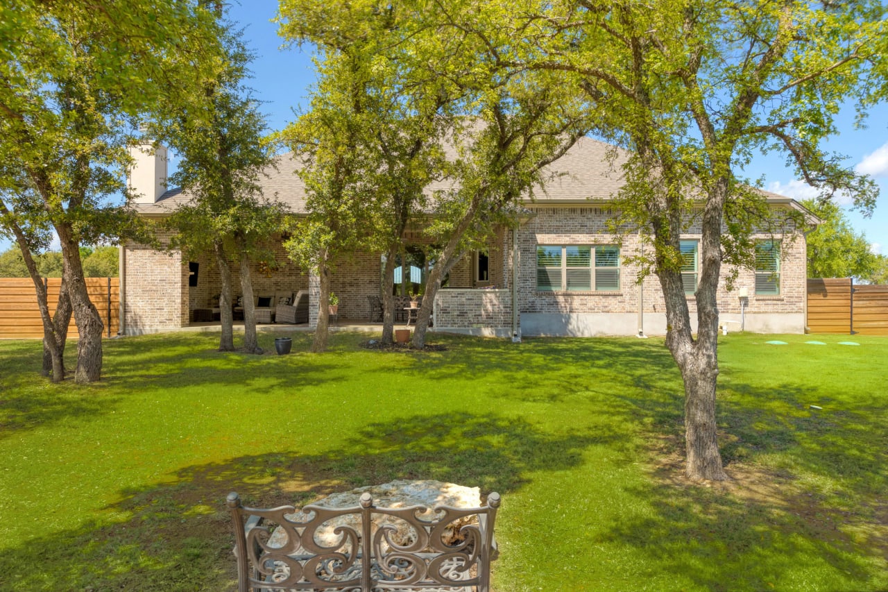 Surrounded by lush greenery and with ample seating, the covered patio offers an idyllic retreat where you can relax, entertain, and unwind in style. Whether you're hosting cookout parties or simply