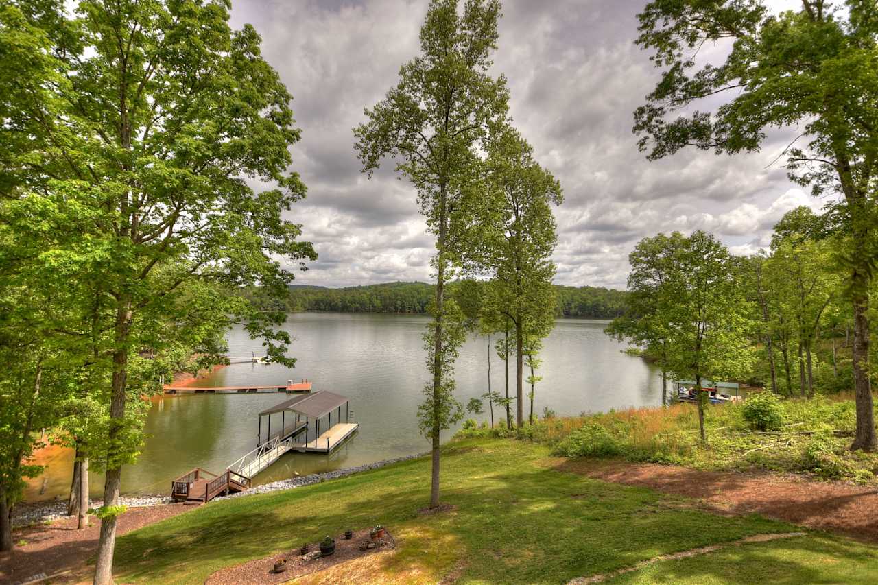 A calm lake with a wooden dock extending out into the water.