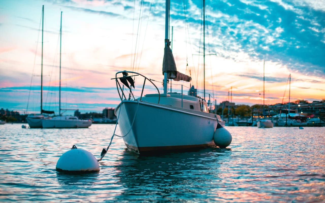 sailboat in a harbor at sunset