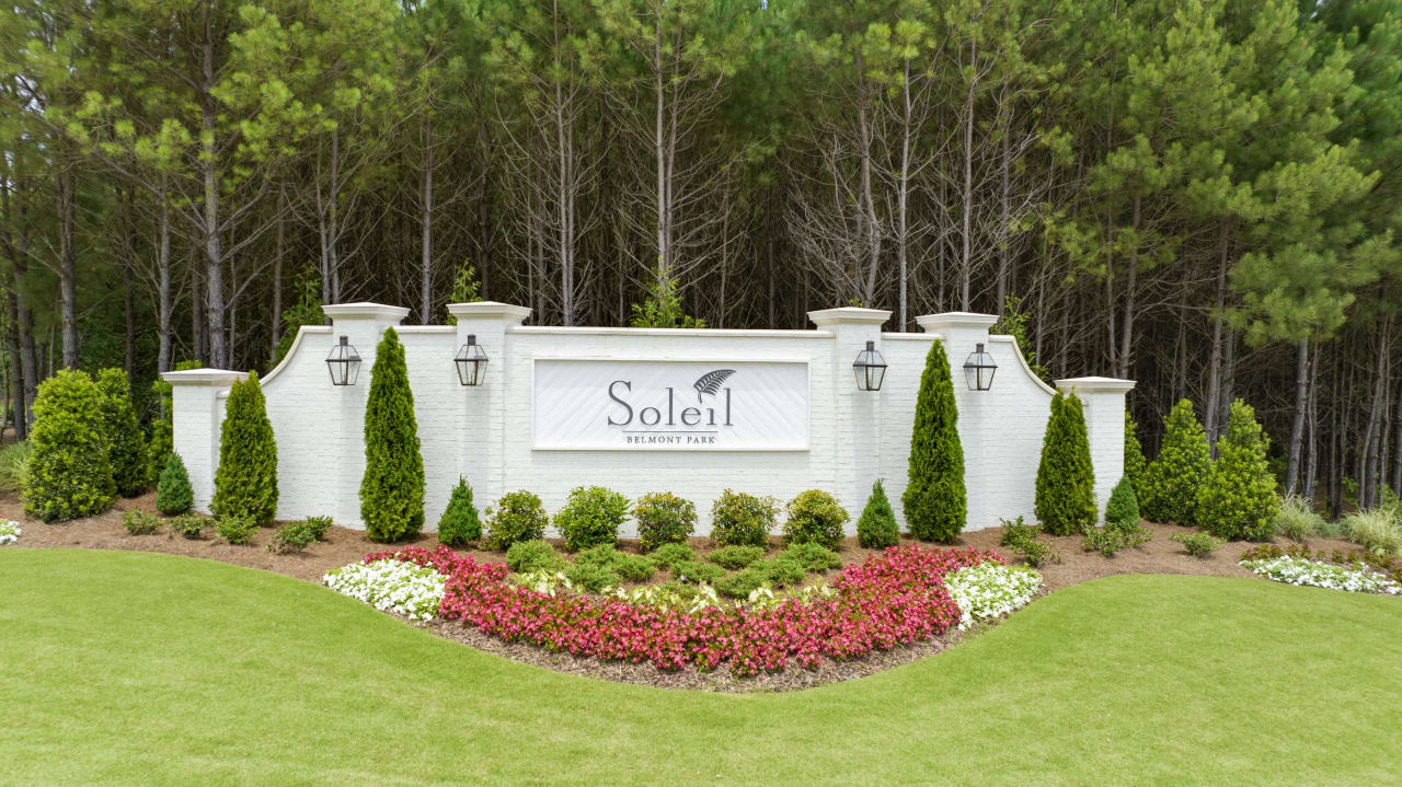 Soleil Belmont Park Neighborhood Entrance sign with flowers and greenery