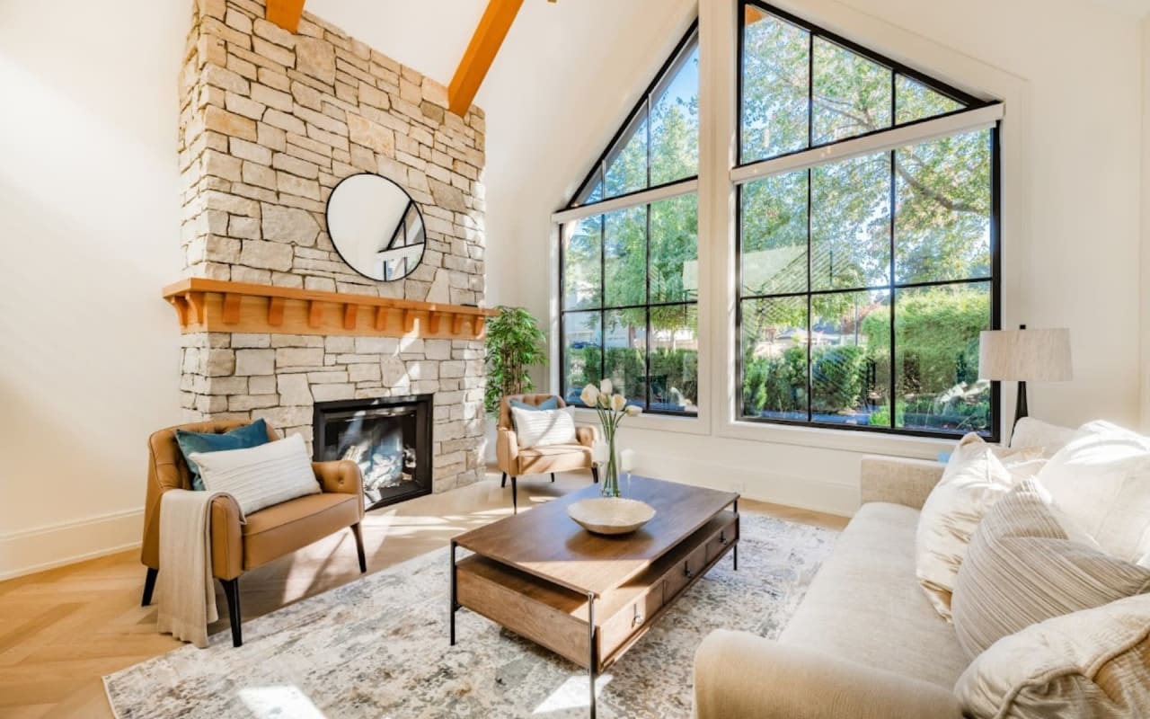 A cozy living room with a fireplace and two chairs.