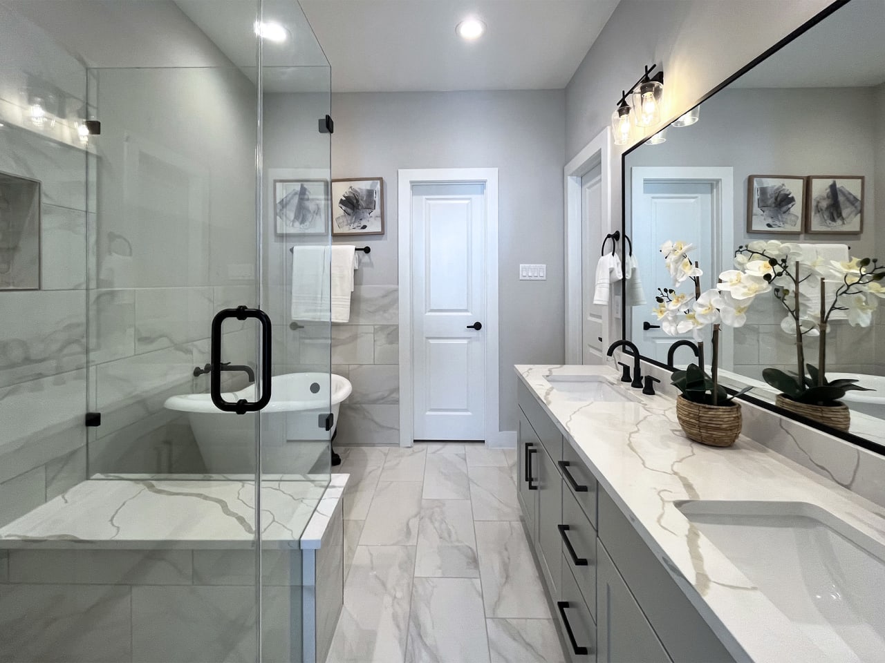 master bathroom with white marble counters in a model home at Commons at Ella Forest