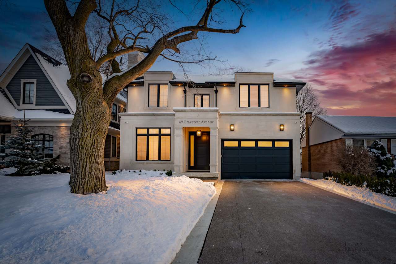 A modern two-story house with a welcoming black garage door