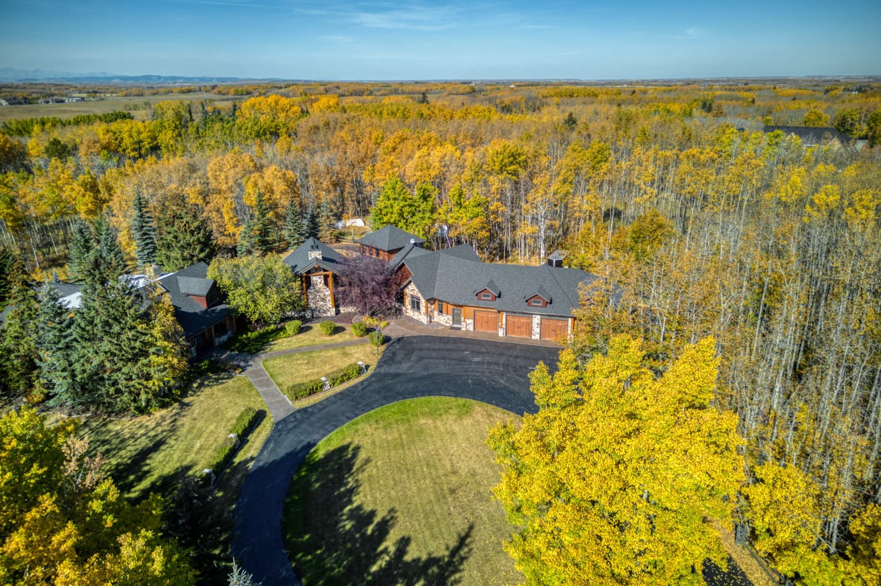 An aerial view of a house surrounded by trees