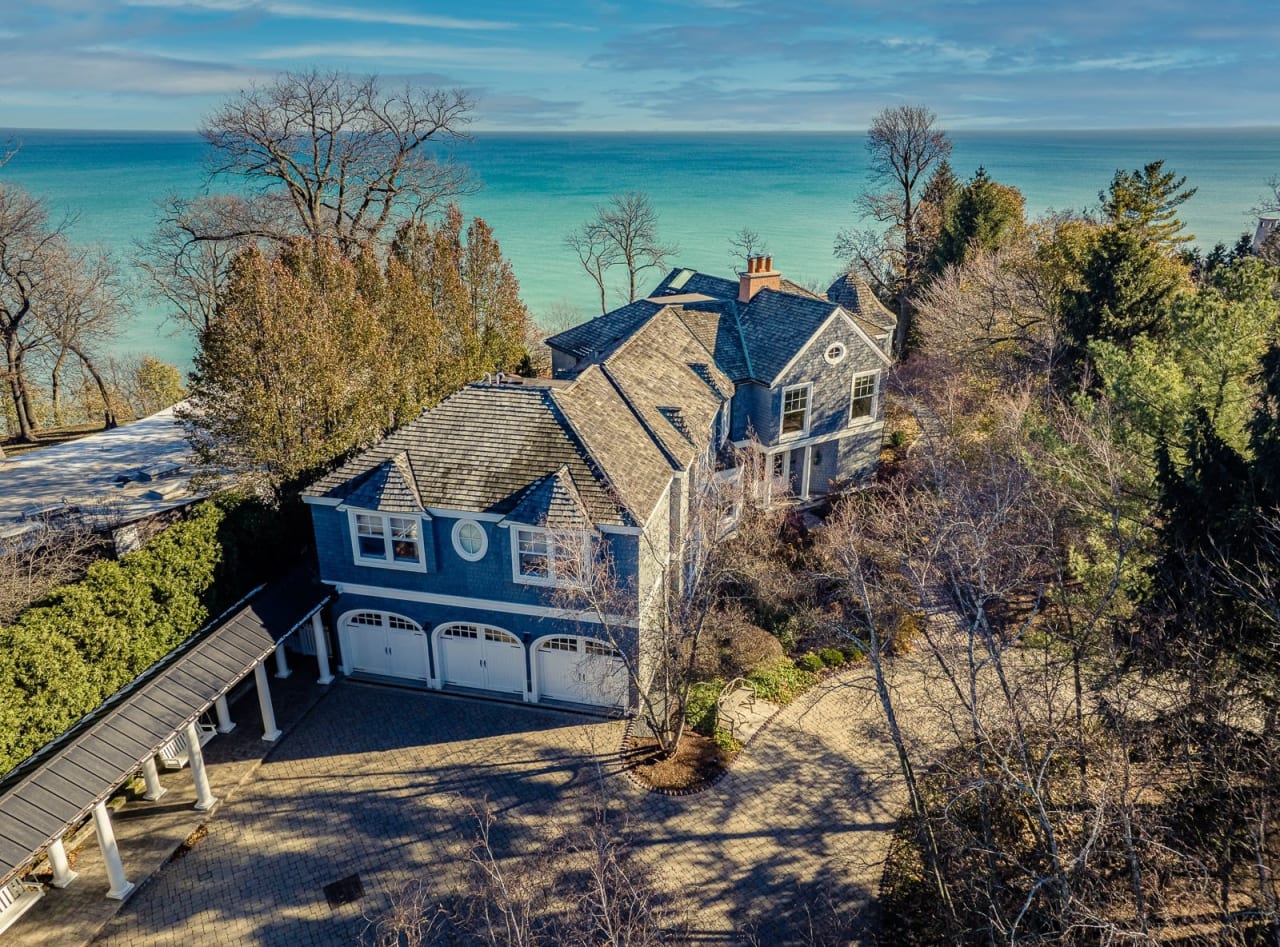 an aerial view of grey luxury beach front house with three carport