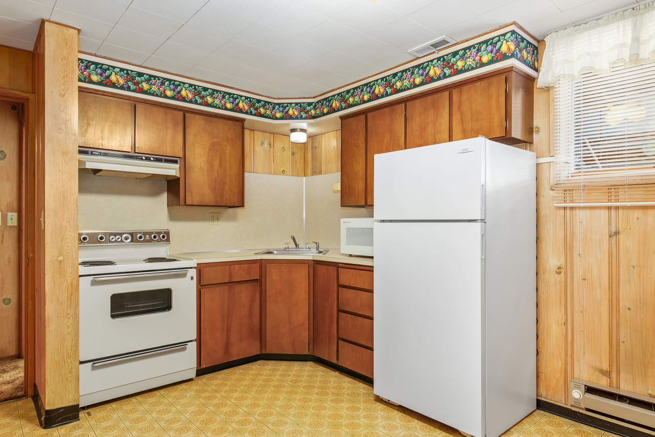 Experience the convenience of a fully equipped kitchen in the downstairs apartment, providing a self-contained culinary haven for independent living.
