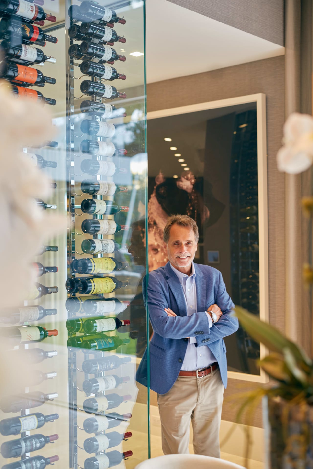 luxury property expert, Tim Elmes leaning in a wine storage