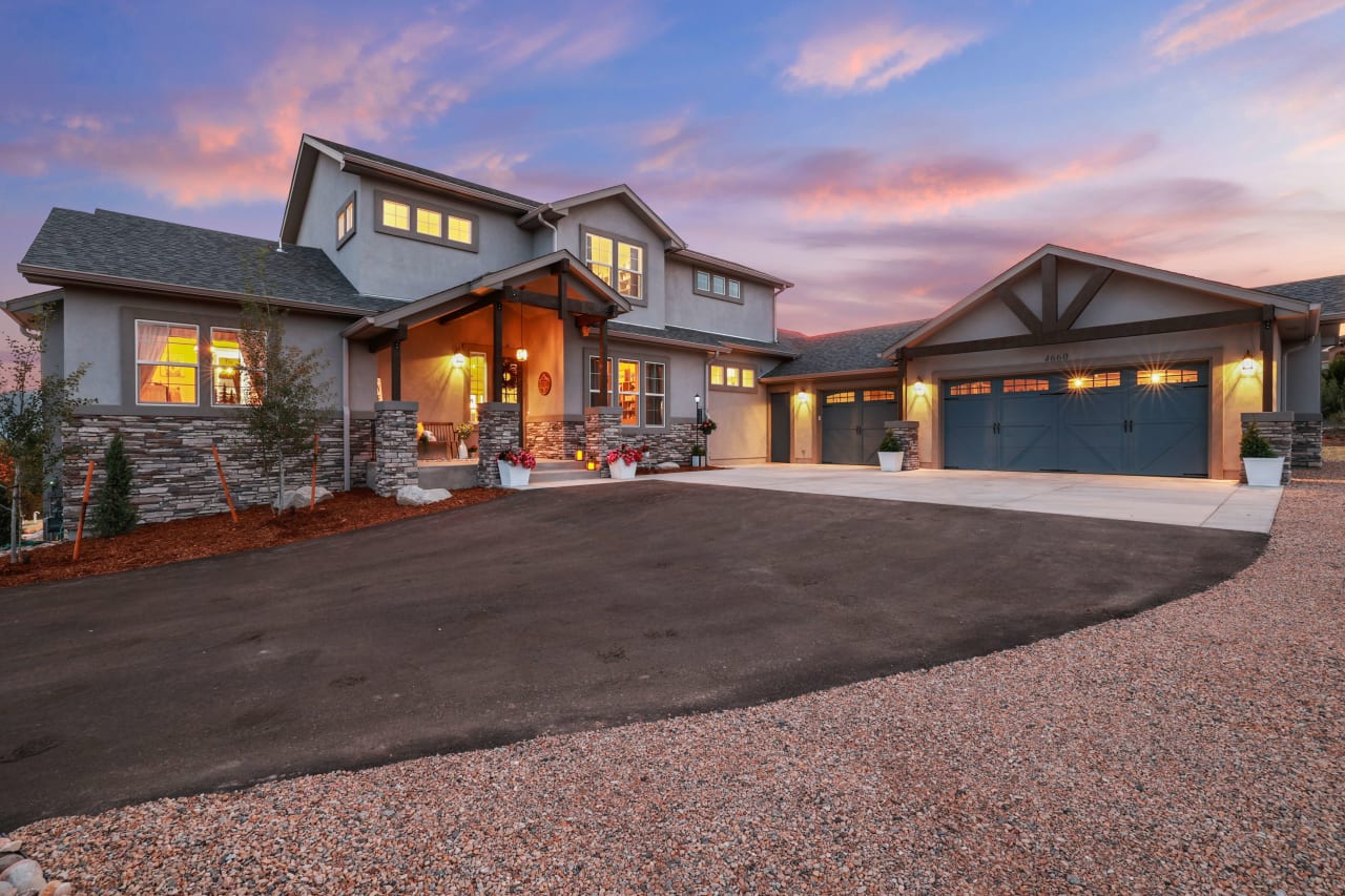 A photo of a large, modern house with a patio.