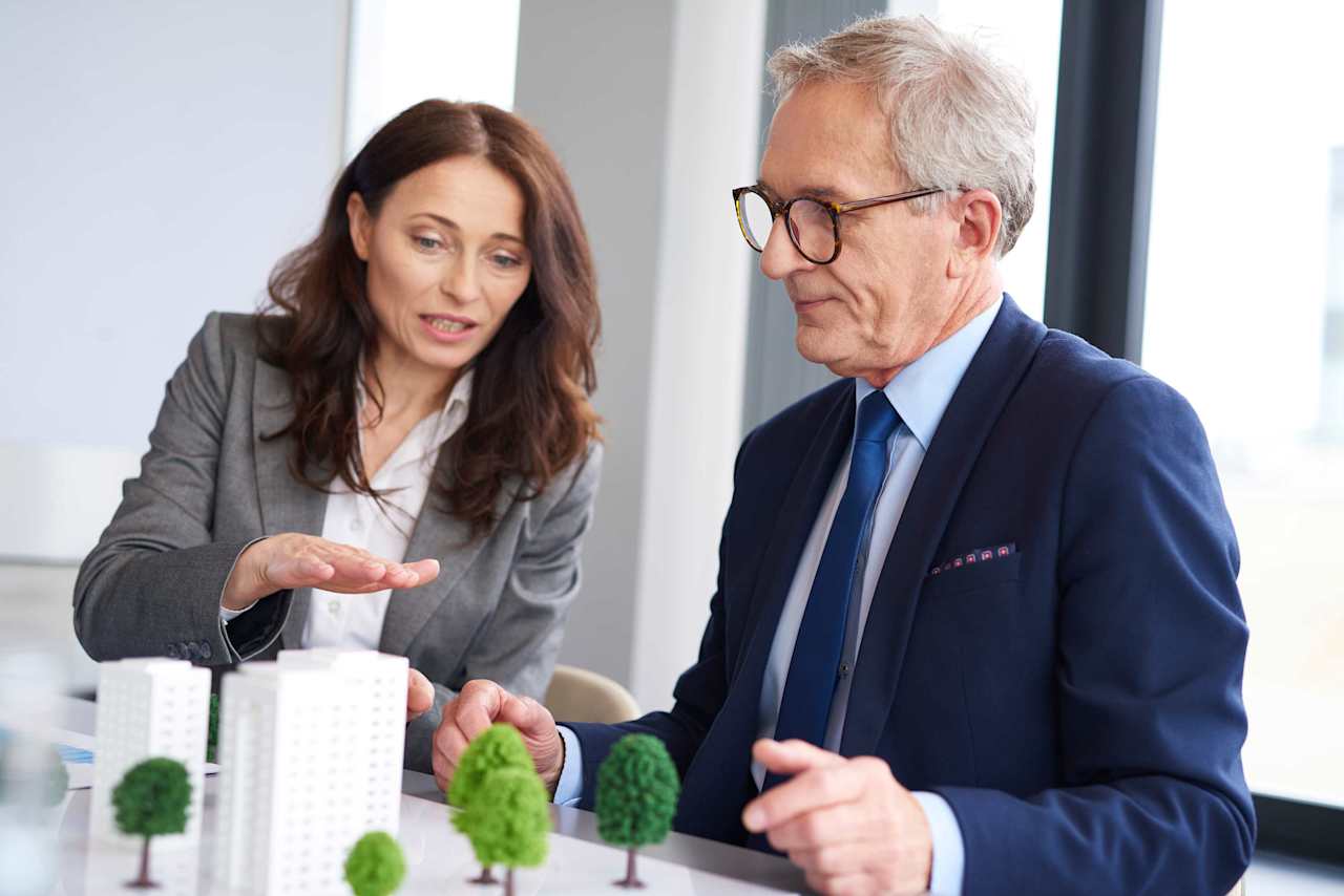 couple looking on real estate property model