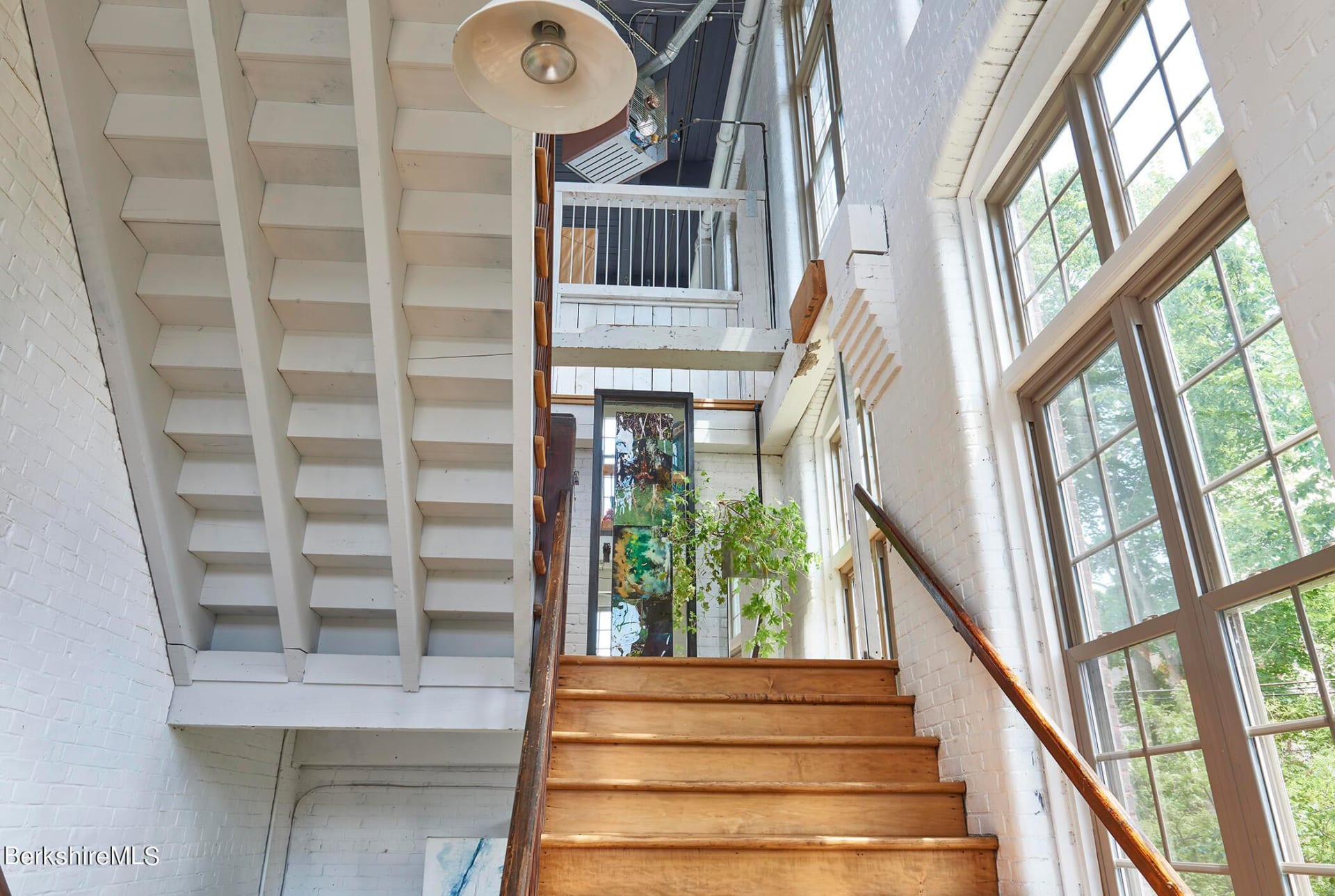 dramatic staircase with tall windows to ceiling 410 Park St