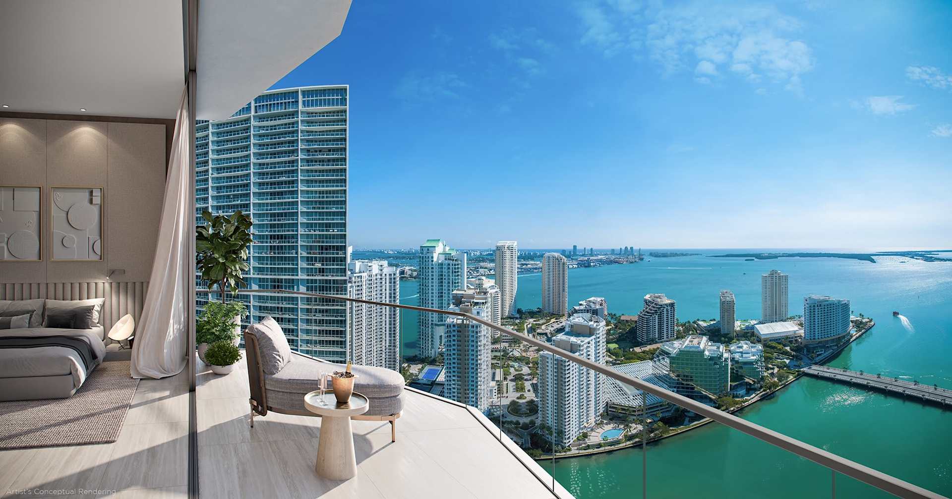 Furnished bedroom opens to a balcony with lounge seating and expansive views of the bay and Miami skyline.