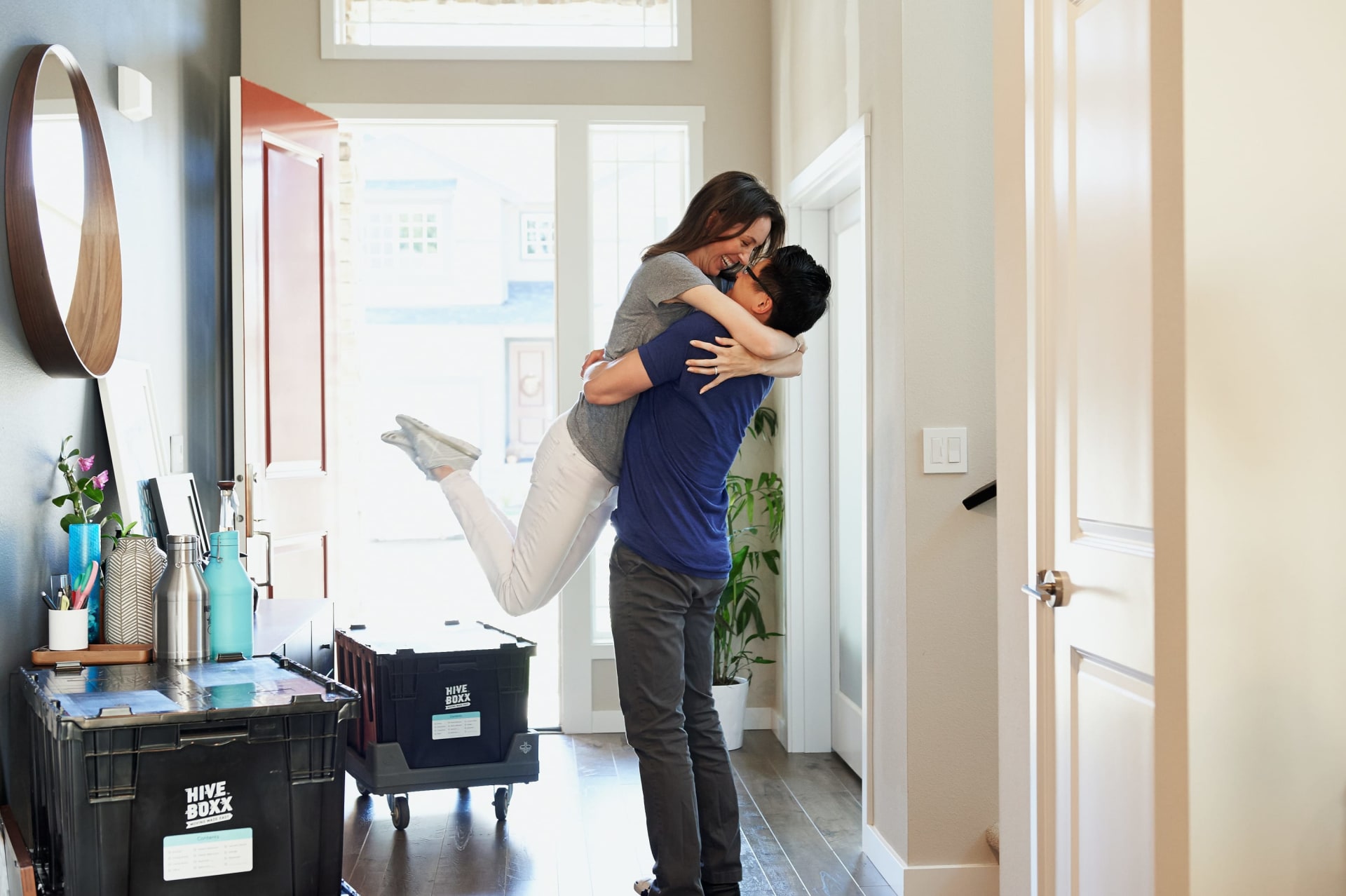 A joyous couple, brimming with excitement, celebrating their move into a new luxury house.