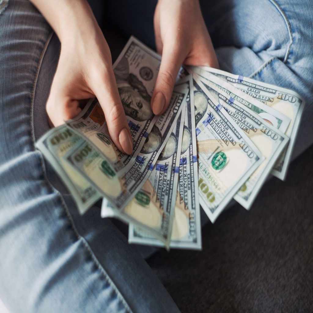 Ecommerce business owner holding cash.