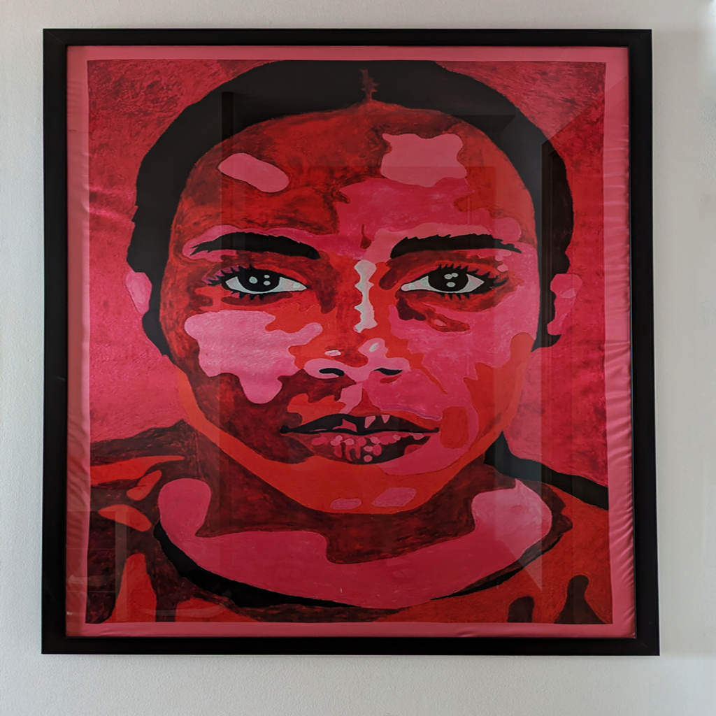 A painting in shades of red and pink of a person looking toward the viewer.