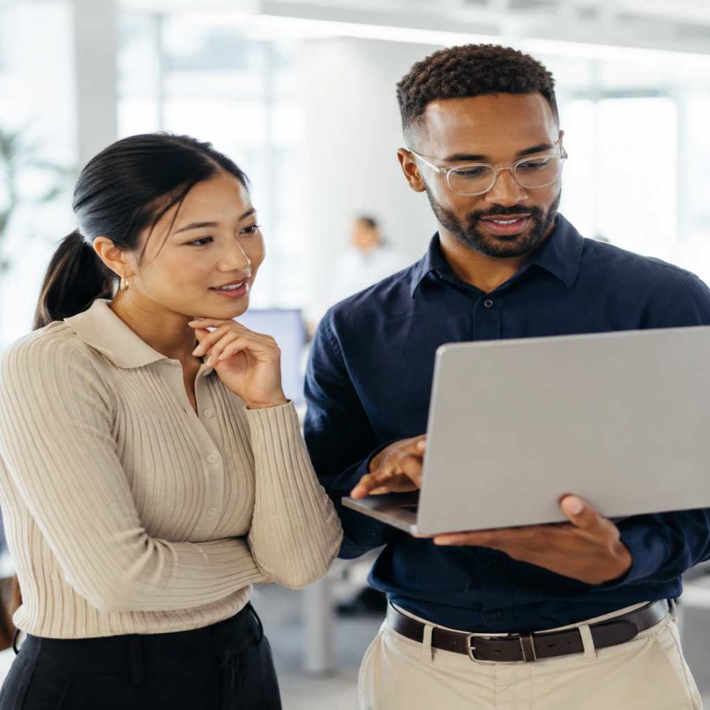 virtualization in cloud computing: two professionals looking at laptop