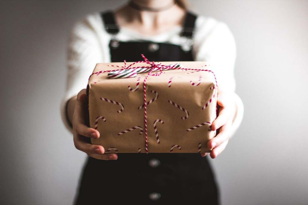Person holding a small package.