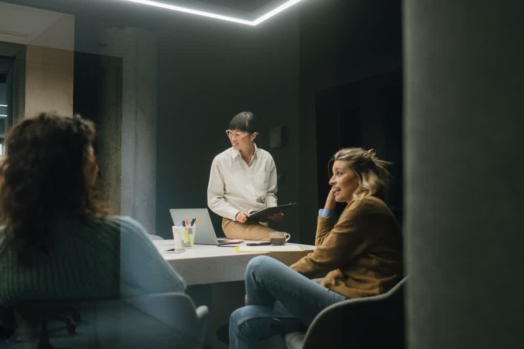 Three lively women who work in the WordPress industry in a meeting about website performance