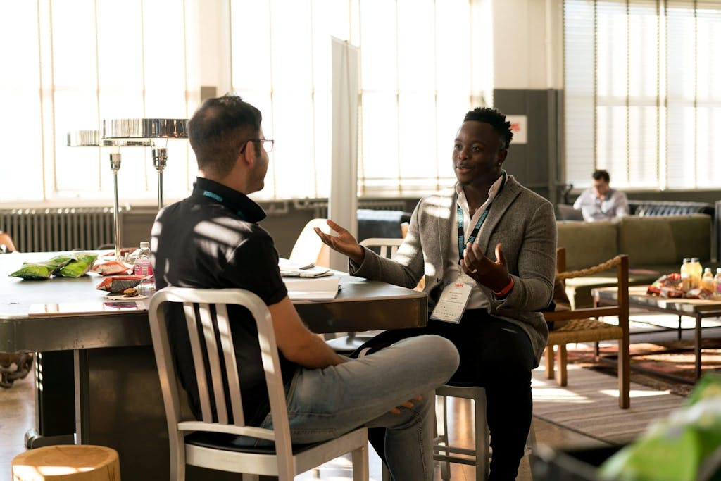 Photo of Two Men Having Business Conversation In A Upscale Hotel Lobby