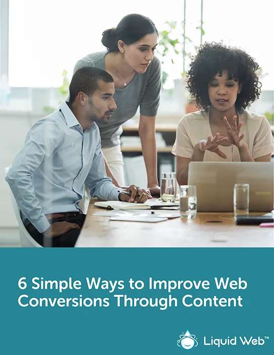 Three coworkers huddled around computer talking through ways of improving web conversions
