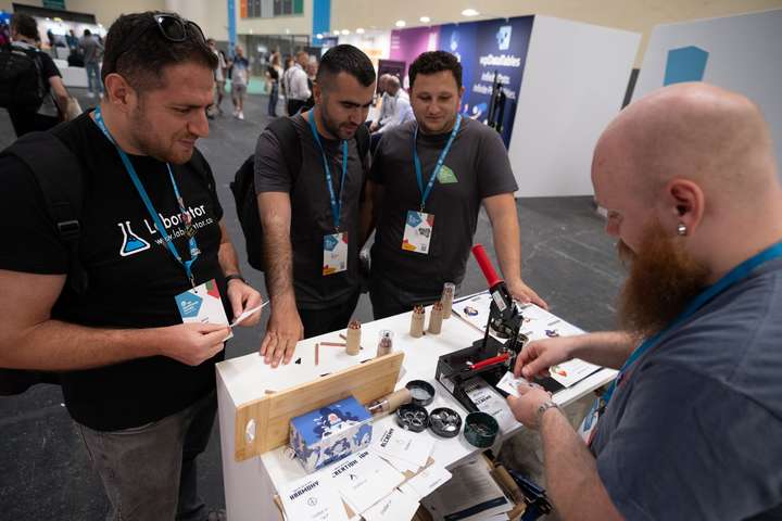 Attendees at the StellarWP booth at WCEU