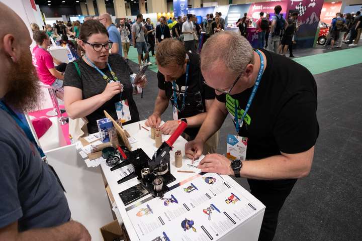 Attendees at the StellarWP booth at WCEU