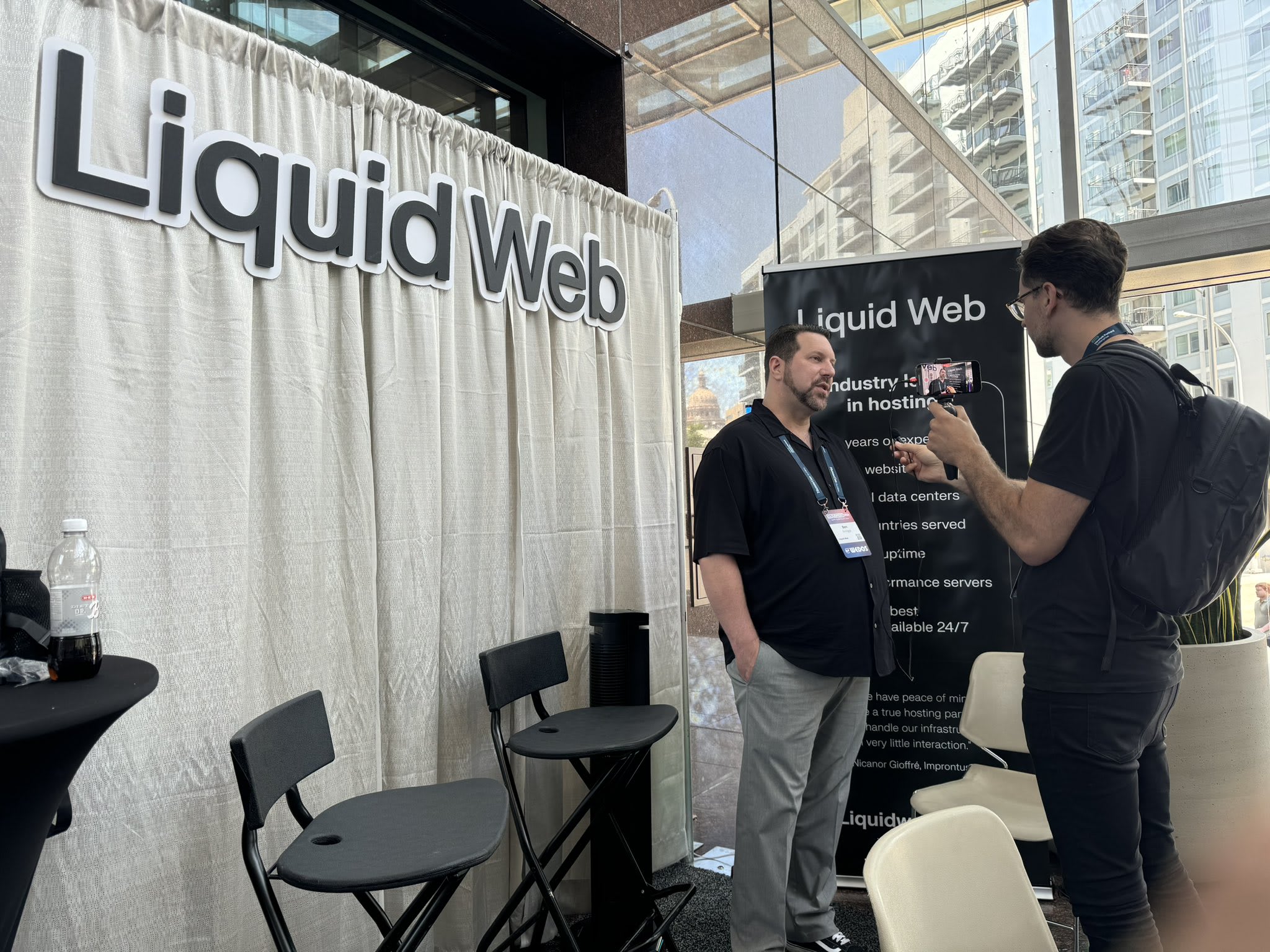 Ben Scroggs speaks with a visitor at the Liquid Web booth