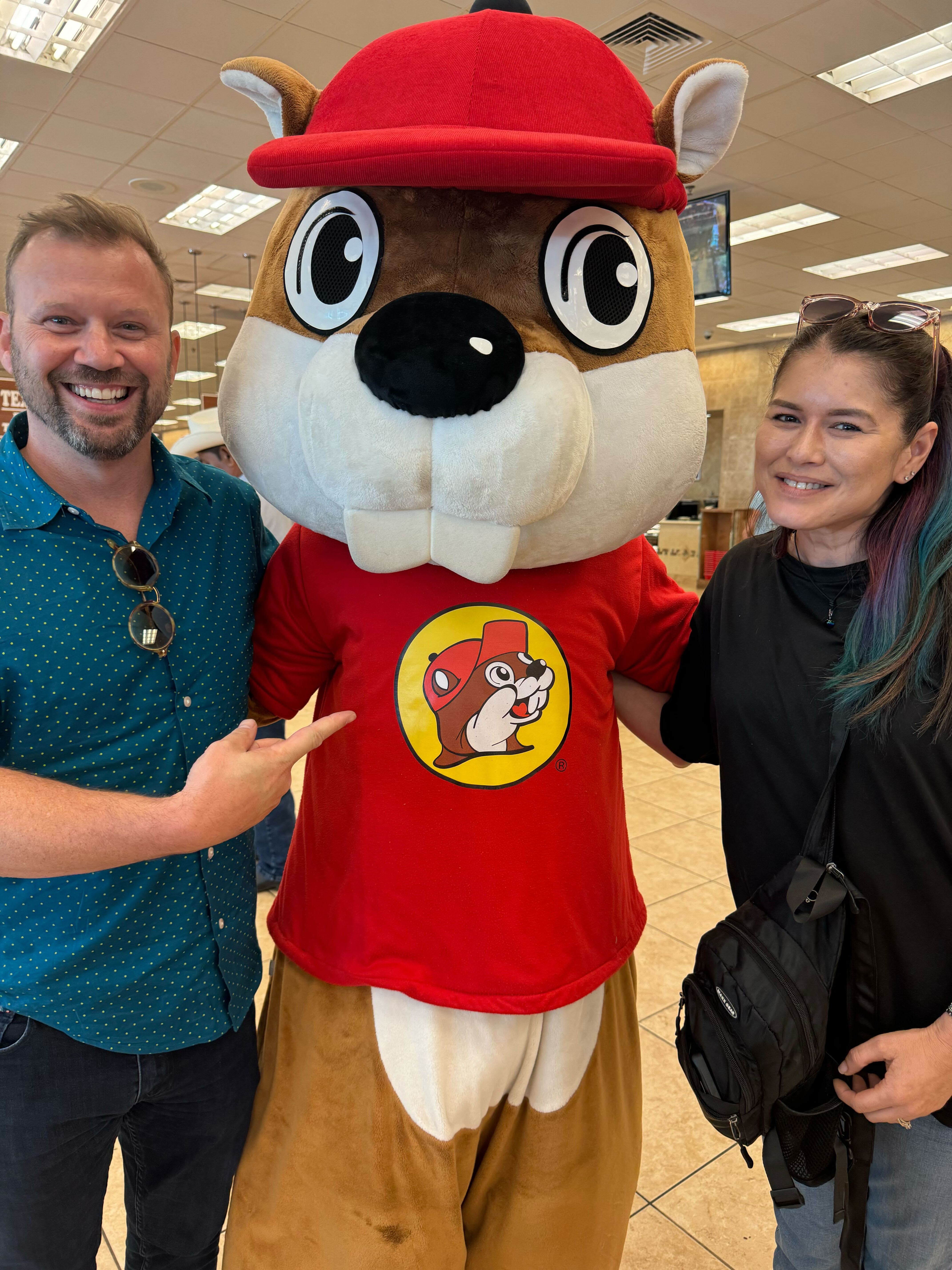 Two Liquid Web employees pose with a beaver mascot