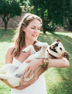 Woman holding dog like baby