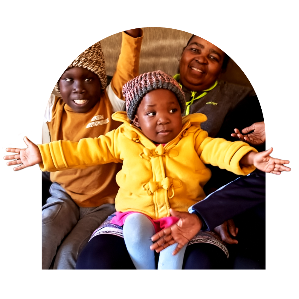 A child celebrating with her caregiver at Marang House